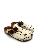 Zuecos Kiko's modelo Austin, con capellada de cuero con estampado animal print de vaca, plantilla de cuero, hebilla de ajuste lateral y suela de goma.
