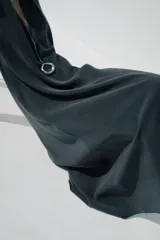 Vestido midi negro de tejido fluido, con cuello halter que se ata al cuello, escote en V y espalda descubierta.