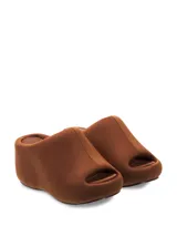 Sandalia negra tipo zueco con suela gruesa, forrada en tela y diseño cómodo.
