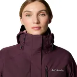 Campera Columbia Whirlibird V Interchange para mujer, color borgoña con interior rosa. Sistema Interchange 3 en 1 con capa exterior impermeable Omni-Tech™ y capa interior aislante Thermator™ de poliéster reciclado. Capucha ajustable, ventilación en las axilas, faldón para nieve, múltiples bolsillos y puños ajustables.