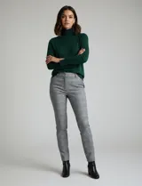 Polera de punto fino marca Nienty, color blanco, con cuello alto volcado y mangas largas con detalle de tajo en los puños.