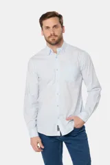 Camisa azul marino de manga larga con bolsillo en el pecho, confeccionada en algodón.