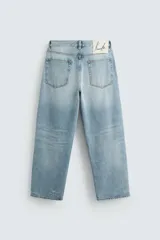 Pantalón de jean celeste de corte amplio, con efecto lavado y roturas.