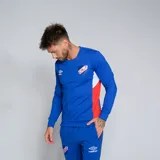 Buzo deportivo Umbro del Club Nacional de Football, modelo Premier, color azul marino con detalles en blanco en los puños y paneles laterales en rojo. Presenta el escudo del club en el pecho.