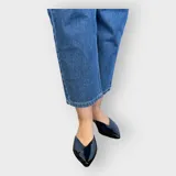 Chatas de cuero negro con punta fina y diseño elegante.
