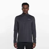 Buzo gris de poliéster reciclado y spandex, con cuello alto y cierre de cremallera hasta el pecho. Tiene mangas largas con orificios para los pulgares y logo de la marca en el pecho.