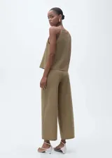 Pantalón palazzo color caqui, de tiro alto y corte crop. Con cintura elástica y confeccionado en tejido de algodón, poliamida y lino.