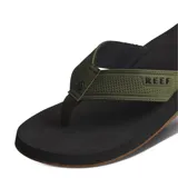 Ojotas Reef The Layback, con base negra y tira de tela verde oliva con logo Reef en relieve.