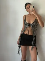 Top de fiesta negro con lentejuelas plateadas, escote en V y tirantes finos.