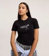 Remera negra de manga corta, corte ajustado al cuerpo, con cuello redondo y estampa frontal en blanco con la palabra "Anxiety" en tipografía cursiva y detalles gráficos.