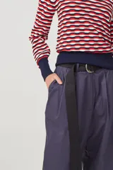 Pantalón de gabardina liviana de algodón color azul marino, de tiro alto con pinzas delanteras que generan volumen, bolsillos americanos y acceso frontal con cartera con cierre metálico.