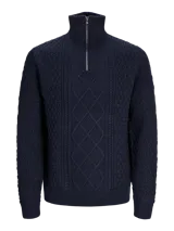 Sweater de punto con cuello alto y cierre metálico a la mitad del pecho. Tejido con diseño de trenzas y rombos.
