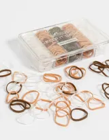Set de 200 gomitas elásticas de silicona en colores marrón, beige y transparente, presentadas en una caja organizadora transparente.