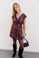 Vestido corto con estampado animal print en tonos naranja, rosa y negro, con detalles en color violeta en escote y ruedo.