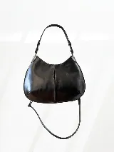 Cartera de cuero negra con doble correa desmontable, una corta y otra larga.