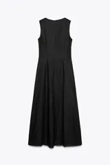 Vestido midi negro de lino con escote cuadrado, sin mangas, con botones dorados en el frente y abertura en el ruedo.