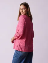 Blusa de broderie color blanco, de mangas largas con puños elásticos.
