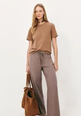 Remera color beige de corte clásico, con cuello redondo y mangas cortas.