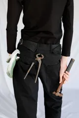 Pantalón de trabajo negro de gabardina con tiro medio, cintura ajustable, cinta utilitaria trasera, bolsillo para metro bordado y cinta reflectiva en los bajos.