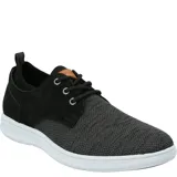 Zapatilla urbana Hush Puppies modelo Port, color tostado, con capellada de cuero y malla, cordones y suela con tecnología ZeroG de EVA.