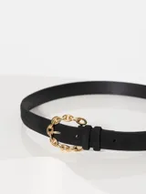 Cinturón regulable de gamuzón negro con forrería de cuero vacuno y aplique en forma de corazón.
