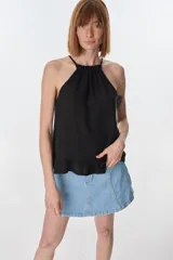 Musculosa color beige de lino, con cuello halter con volados y volados en el ruedo.