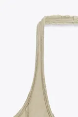 Vestido corto color beige con cuello halter y falda con godets.