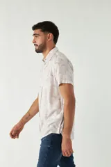 Camisa de hombre estampada, de manga corta y fit slim. Presenta cartera abotonada y logo bordado.
