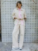 Pantalón de jean color arena, de corte recto y tiro medio.