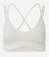 Top deportivo blanco de microfibra, con escote en V y tirantes finos que se cruzan en la espalda en forma de X.
