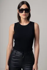 Musculosa negra de tejido de punto acanalado, con cuello redondo y corte ajustado.
