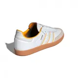 Championes Adidas Samba OG de cuero blanco con detalles en naranja y suela de goma marrón.
