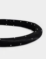Vincha rígida color negro con apliques de strass plateados.