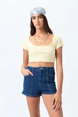 Short de jean de tiro alto, color celeste claro, con bolsillos frontales y traseros, y cierre frontal con botón metálico.