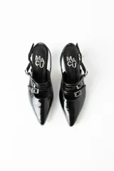 Zapatos de tacón negros de charol con punta fina, múltiples correas con hebillas plateadas y logo de la marca en la plantilla.