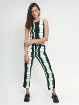 Pantalón de crepé con estampado geométrico en verde, blanco y negro. De corte recto y tiro medio/alto con pretina con cierre y botón.