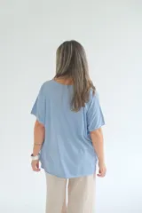 Remera celeste de corte amplio, con cuello en V y mangas cortas.