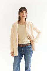 Blazer azul marino de tela agamusada, corte clásico, con solapas y bolsillos frontales.