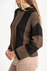 Sweater de tejido de punto grueso, con diseño de rayas verticales anchas en tonos marrón oscuro y negro. Presenta cuello redondo y mangas largas.