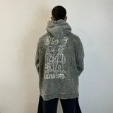 Canguro gris con efecto gastado y estampado de Popeye en la espalda. Corte oversize.