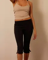 Pantalón capri negro de lycra suplex premium con faja a la cintura, dobladillo por debajo de la rodilla y tajos en el ruedo.