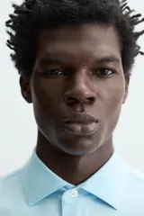 Camisa negra de manga larga con cuello italiano abierto y cierre frontal de botonadura. Corte slim fit.