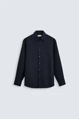 Camisa negra de manga larga con cuello italiano y cierre frontal de botonadura. Presenta un tejido con estructura de fácil cuidado.