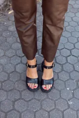 Sandalias negras de cuero con textura de cocodrilo, plataforma delantera y tacón geométrico.