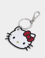 Llavero metálico esmaltado con la forma de la cabeza de Hello Kitty, con moño rojo y detalles en negro.