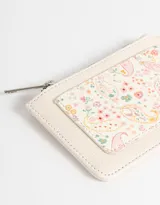 Tarjetero de cuerina con estampado floral multicolor, cierre superior con cremallera y bolsillo frontal abierto.