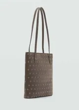 Bolso tipo tote de cuero color celeste con perforaciones circulares. Tiene doble asa corta y bolsillo interno.