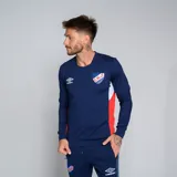 Buzo deportivo Umbro del Club Nacional de Football, modelo Premier, color azul marino con detalles en blanco en los puños y paneles laterales en rojo. Presenta el escudo del club en el pecho.
