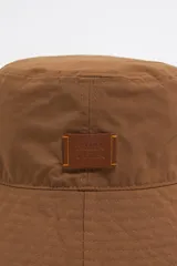 Gorro tipo bucket negro de tejido gabardina con etiqueta de piel logotipada.