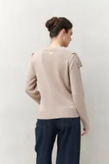 Sweater color crema de punto liso con detalle de crochet en el escote y en forma de pico sobre el pecho.